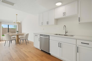 Kitchen with stainless steel dishwasher, a sink, 