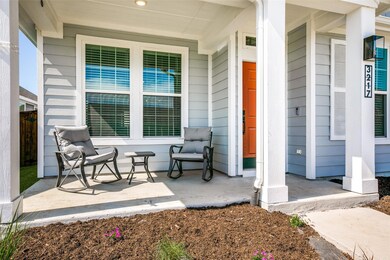 New landscaping surrounds the front porch which is