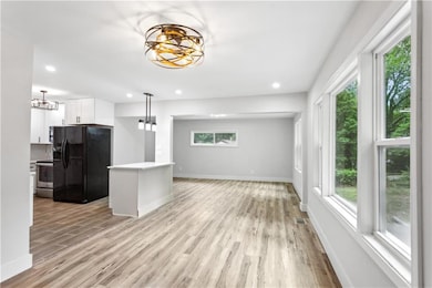 Kitchen with black refrigerator with ice dispenser