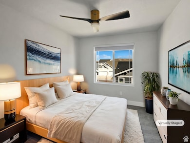Bedroom with baseboards, dark carpet, and ceiling fan