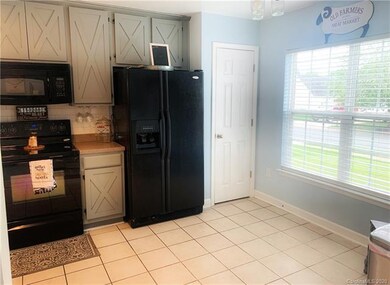 Pantry Closet and Kitchen View, All Black Applianc
