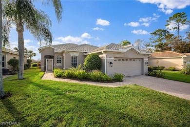 Mediterranean / spanish-style house featuring stucco siding, decorative driveway, a tile roof, and a front yard