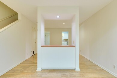 Hallway featuring wood finished floors, baseboard