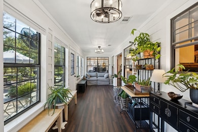 Front sun room with views of the private backyard and patio for entertaining