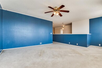 Unfurnished room with a textured ceiling, carpet f