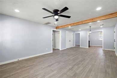 Unfurnished living room featuring beamed ceiling, 
