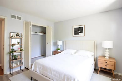 Bedroom featuring wood finished floors and a closet