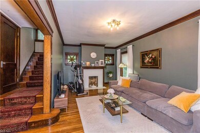 Living room with ornamental molding and hardwood floors