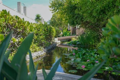 TRANQUIL POND IN FRONT OF UNIT. BLOOMING TIGER LILLIES.