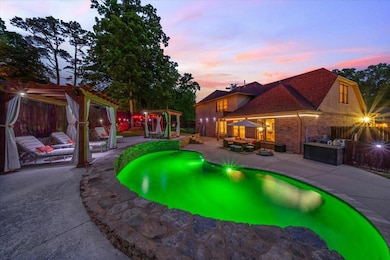 Pool at dusk with a pergola, a patio area, and fence