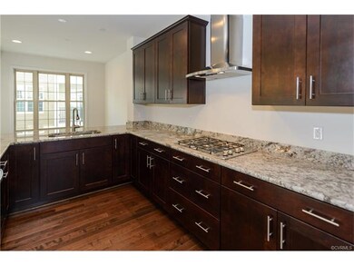 Custom kitchen with stainless steel range hood ove