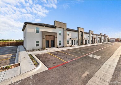 View of property featuring fence, a residential view, and uncovered parking