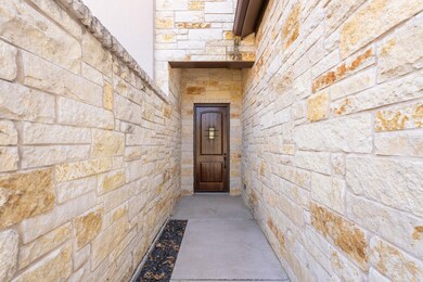 Doorway to property with stone siding