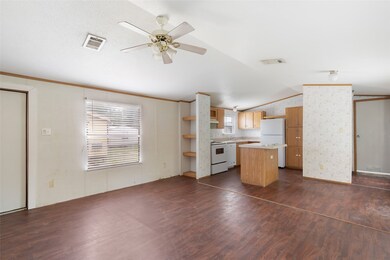 This photo shows a bright, open-plan living area w
