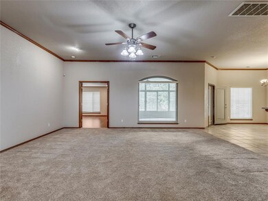 Unfurnished living room featuring ceiling fan with