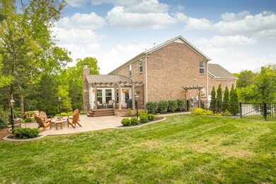 There is ample yard just off the patio for the children to play or the dogs to lounge. Trees and professional landscaping surround the entire yard. 