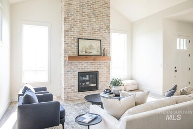 Living room featuring lofted ceiling, wood finished floors, and a fireplace