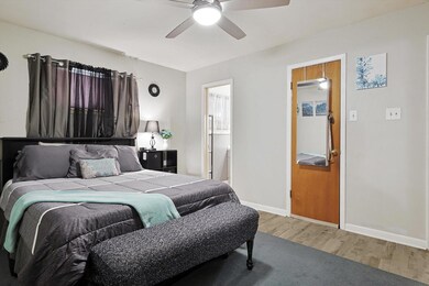 Recently updated primary bedroom with walk-in closet, attached half bath, new paint and new floors.