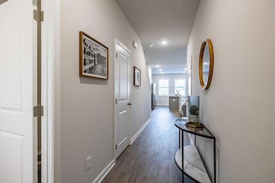 Hallway with dark hardwood / wood-style floors
