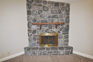 Wood burning fireplace with mantel and raised hear