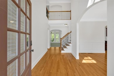 Foyer entrance with stairway, crown molding, wood 