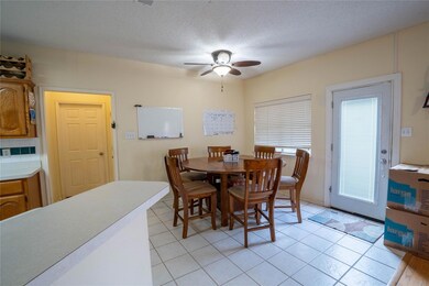 Tiled dining space with a textured ceiling and cei