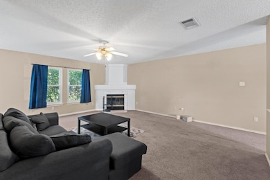 Living area featuring ceiling fan, baseboards, a 