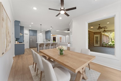 The dining room with views to the covered patio and open s to the kitchen and living room.  Virtually staged