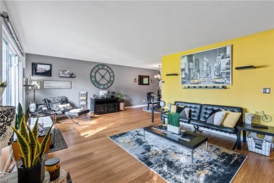 Bright spacious living room & dining room.  Kitchen behind yellow accent wall.