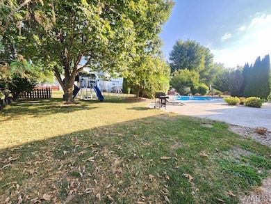 View of yard featuring a playground and a patio area