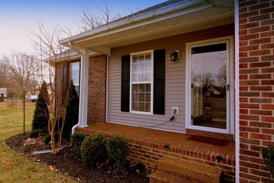 This covered front porch is waiting for you to add a couple of rockers here...