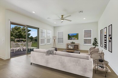 Living area with a ceiling fan, wood finished flo
