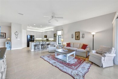 Tiled living room featuring ceiling fan