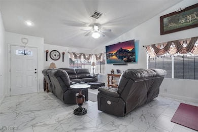 Living area featuring baseboards, recessed lightin