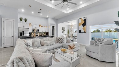 Living room with a towering ceiling, a raised ceil