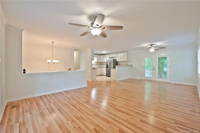 Open plan with Living Room/Dining Area featuring ceiling fans/lights & access to deck!