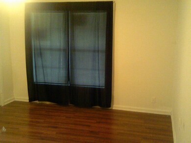 Empty room with dark hardwood / wood-style floors
