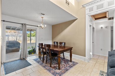 Tiled dining room featuring a notable chandelier a