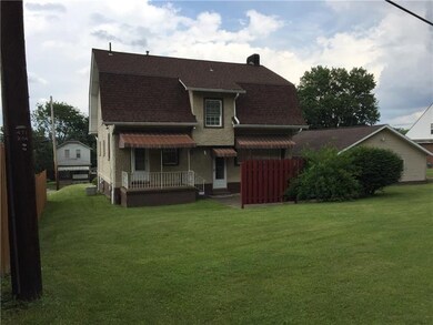 Rear view of home and garage