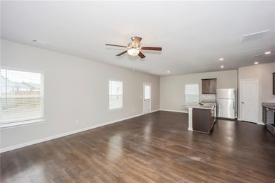 Unfurnished living room with ceiling fan, plenty o