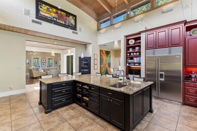 Kitchen with a kitchen bar, wood ceiling, stainles