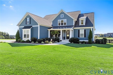 View of front of house featuring covered porch, a standing seam roof, a shingled roof, and board and batten siding