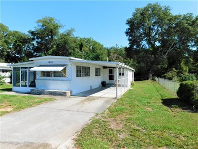 Side of home with carport.