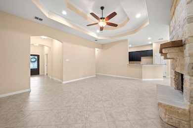 Unfurnished living room with crown molding, a tra
