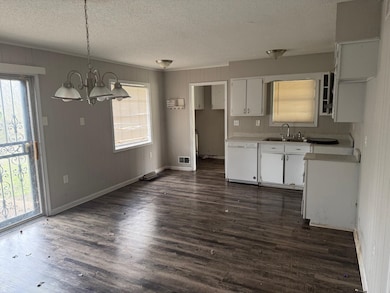 Kitchen featuring dark wood-style flooring, dishwa