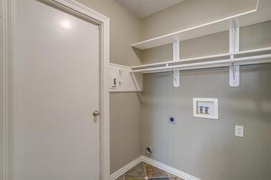 Washroom featuring tile patterned floors, hookup f