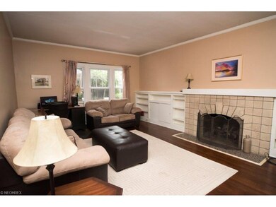 Formal living room with crown molding, built-ins a