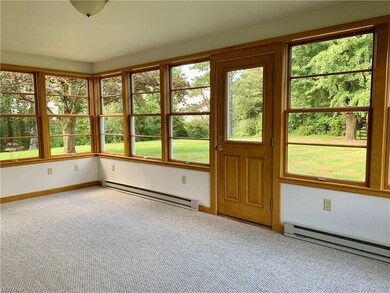 Sun Room off the kitchen with views of the wooded 