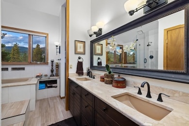 Full bathroom with a shower stall, a bath, double