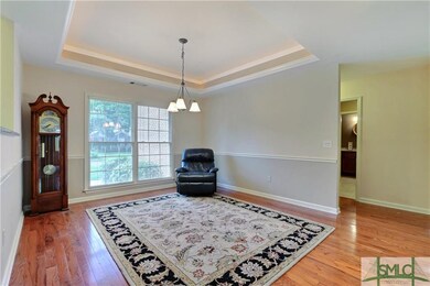 The formal dining room boasts custom-lit trayed ce